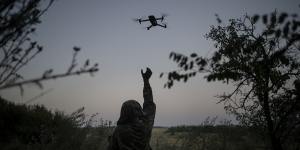 A Ukrainian drone pilot reaches for a reconnaissance drone in the Luhansk Region,Ukraine.