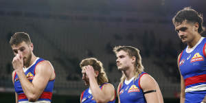 Western Bulldogs players leave the field after the loss to West Coast. 