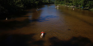 Police have been told the man,believed to be aged 41,was with five other men on separate inflatable lilos when he became wedged on a large submerged rock about 1pm at Colo River.