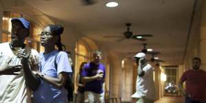 People concerned about relatives seek information from police nearby the scene of a shooting at the Emanuel AME Church in Charleston.