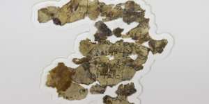 The fragments of parchment bear lines of Greek text.