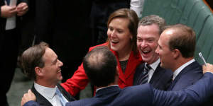 Environment Minister Greg Hunt (left) is congratulated by colleagues including Christopher Pyne and Kelly O'Dwyer.