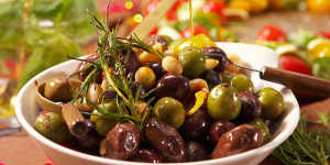 Warm olives with macadamias and chilli