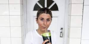 Claudia Bodycomb enjoys a juice from Melon Head in Coogee on 24 February,2022. 