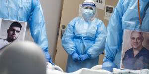 Medical staff wear their photos outside their PPE while checking on a patient at a COVID-19 intensive care unit in Houston,Texas.