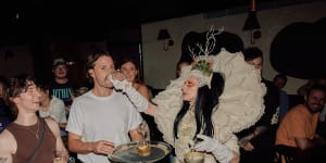 A roaming performer helping a customer with their drink at Pleasure Club,Newtown.