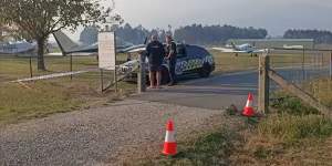 Police at Mount Beauty airport on Saturday.