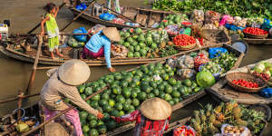 Vietnamese women selling and buying fruits on floating market,Mekong River Delta.