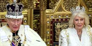 King Charles III and Queen Camilla smile during the King’s Speech in the House of Lord’s Chamber during the State Opening of Parliament on Wednesday.