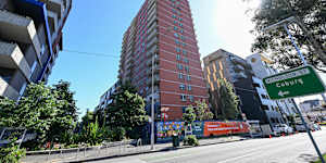 Demolition has begun on the red brick public housing tower in Nicholson Street,Carlton.