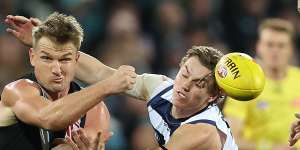 Ollie Wines of the Power and Tanner Bruhn of the Cats during the Round 14 match.
