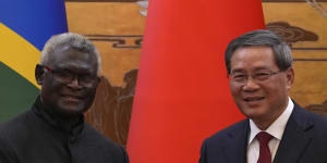 Visiting Solomon Islands Prime Minister Manasseh Sogavare shakes hands with Chinese Premier Li Qiang.
