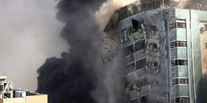 The building housing the offices of the Associated Press and other media in Gaza City collapses after it was hit by an Israeli air strike.