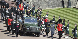Prince Philip’s coffin,borne on the Land Rover he helped to design,is flanked by Pall Bearers during his funeral procession in 2021.