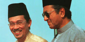 Anwar Ibrahim,left,stands next to Malaysian Prime Minister Mahathir Mohamad in 1998.