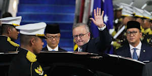 Albanese waves to journalists on his arrival at Halim Perdanakusuma airbase in Jakarta,Indonesia. 