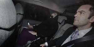 Judy Moran’s last ride from freedom in 2009. In police car with Stuart Bateson
