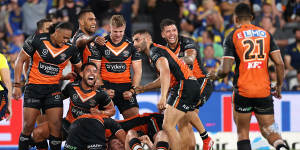 Wests Tigers swamp Jackson Hastings after his match-winning field goal.