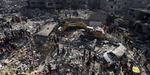 Palestinians look for survivors under the rubble of destroyed buildings following the first Israeli airstrikes on the Jabalia refugee camp,northern Gaza Strip thsi week.