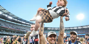 Norm Smith medallist Bobby Hill celebrates with Bobby Hill jnr.