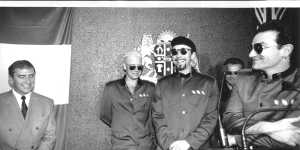 U2 meets then NSW Premier John Fahey in Sydney and presents him with a new pair of sunglasses.