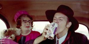 Humphries as Aunty Edna with Barry Crocker in a London taxi in a scene from The Adventures of Barry McKenzie.