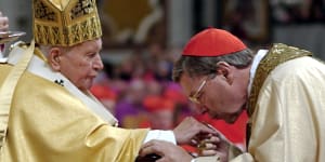 Cardinal George Pell of Australia,Archbishop of Sydney kisses Pope John Paul II’s hand after receiving his ring during a Mass with the newly elevated Cardinals in St. Peter’s Basilica,at the Vatican in 2003.