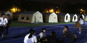 People evacuated from their homes sit outside the shelter after the main earthquake in Hualien City,eastern Taiwan.
