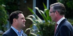 NSW Premier Dominic Perrottet (right) talks with Stuart Ayres at a media event on Monday.