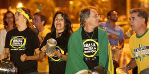 Members of the Brazil's Movement Against Corruption bang on pots and pans in protest against President Dilma Rousseff,during her televised speech.