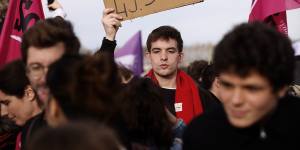 A protester holds a placard during a gathering at Concorde square near the National Assembly in Paris.