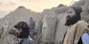 Afghans look at the destruction caused by an earthquake in the province of Paktika,eastern Afghanistan.