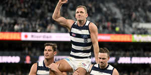 Joel Selwood is chaired off by Tom Hawkins and Mitch Duncan following his 350th game.