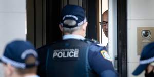 Moses Obeid talks to police at his Paddington home.