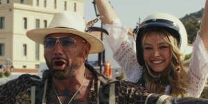 Dave Bautista as Duke and Madelyn Cline as Whiskey in Glass Onion.