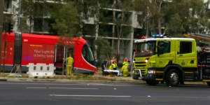 Emergency services tend to a pedestrian after they were hit by a tram on Canberra's light rail network.