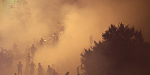 Lebanese riot police fire tear gas during a protest against government's plans to impose new taxes in Beirut,Lebanon.