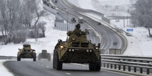 A convoy of Russian armoured vehicles moves along a highway in Crimea this month. 