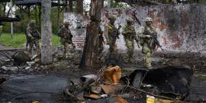 Russian troops walk in a destroyed part of the Illich Iron&Steel Works Metallurgical Plant in Mariupol on May 18.