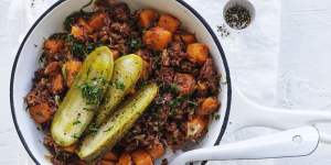 Corned beef and sweet potato hash with American pickles.