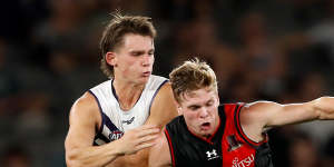 Caleb Serong of the Dockers and Ben Hobbs of the Bombers battle for possession. 