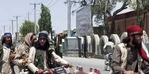 Taliban fighters patrol inside the city of Ghazni on Thursday.