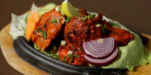 Sizzling chicken tikka kebab.