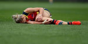 Erin Phillips clutches her knee after going down in the third quarter of the grand final.