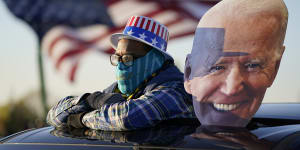 A Democrat supporter watches Joe Biden address a rally in Michigan on Saturday.