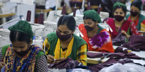 Bangladeshi garment employees wearing masks.