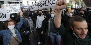 Demonstrators in Paris hold banners during a banned protest in support of Palestinians on Saturday. 