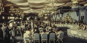Guests enjoy champagne and foie gras in the banquet tent at the Shah’s 1971 party.