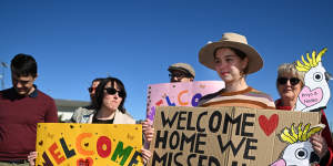 Supporters of the Nadesalingam family hold welcome signs ahead of their return to Biloela in June 2022.