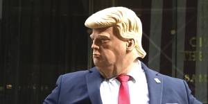 A Donald Trump impersonator directs traffic in front of Trump Tower.